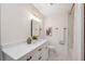 Clean bathroom with white vanity, bathtub and wood accent wall at 2004 Virginia Dr, Bradenton, FL 34205