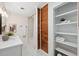 Bathroom with white vanity, built-in shelving and bathtub at 2004 Virginia Dr, Bradenton, FL 34205