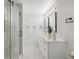 Modern bathroom with double vanity, herringbone tile floor and walk-in shower at 2004 Virginia Dr, Bradenton, FL 34205