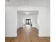 Bright hallway with light wood floors leading to the back of the house at 2004 Virginia Dr, Bradenton, FL 34205