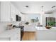 Modern white kitchen with stainless steel appliances and island at 2004 Virginia Dr, Bradenton, FL 34205