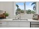 Modern kitchen sink with gold faucet and large window at 2004 Virginia Dr, Bradenton, FL 34205