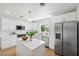 Modern white kitchen with island and stainless steel appliances at 2004 Virginia Dr, Bradenton, FL 34205