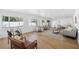 Sunlit living room featuring light wood floors, ample seating and a large rug at 2004 Virginia Dr, Bradenton, FL 34205