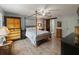 Main bedroom with a four-poster bed and ensuite bathroom at 2022 Hawkhurst Cir, Sun City Center, FL 33573