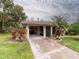 Front view of home with golf cart garage and porch at 2022 Hawkhurst Cir, Sun City Center, FL 33573