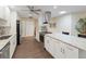 Modern white kitchen with granite countertops and stainless steel appliances at 2022 Hawkhurst Cir, Sun City Center, FL 33573