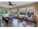 Relaxing sunroom with ample natural light and wicker furniture at 2022 Hawkhurst Cir, Sun City Center, FL 33573