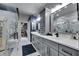 Modern bathroom with gray cabinets and marble shower at 204 Latitude Pl, Apollo Beach, FL 33572