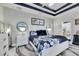 Spacious bedroom with blue and white bedding, and stylish ceiling design at 204 Latitude Pl, Apollo Beach, FL 33572