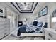 Relaxing bedroom with white plantation shutters and a view of the backyard at 204 Latitude Pl, Apollo Beach, FL 33572