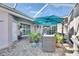 Relaxing patio with seating area and umbrella at 204 Latitude Pl, Apollo Beach, FL 33572