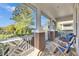 Peaceful screened porch with two wooden chairs and lush view at 204 Latitude Pl, Apollo Beach, FL 33572