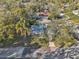 Aerial view of a single-Gathering home with a metal roof and driveway at 2300 Lancaster Dr, Clearwater, FL 33764