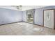 Living room with tile floor, large window, and door at 2300 Lancaster Dr, Clearwater, FL 33764