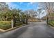 Gated community entrance with palm trees and landscaping at 2400 Feather Sound Dr # 913, Clearwater, FL 33762