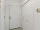 Apartment entryway with white door and storage closet at 2400 Feather Sound Dr # 913, Clearwater, FL 33762