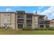 Condo building showcasing multiple balconies and a manicured lawn at 2400 Feather Sound Dr # 913, Clearwater, FL 33762