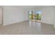 Bright living room with tile floors and sliding glass doors at 2400 Feather Sound Dr # 913, Clearwater, FL 33762