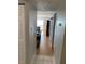 View down hallway with light wood floors and doors to other rooms at 2625 State Road 590 # 532, Clearwater, FL 33759