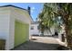 White garage with light green door and gravel driveway at 2660 Miriam S St, Gulfport, FL 33711