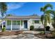 Charming bungalow with white siding, green shutters, and a landscaped front yard at 2660 Miriam S St, Gulfport, FL 33711