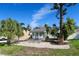 Quaint white house with green shutters and palm trees in the front yard at 2660 Miriam S St, Gulfport, FL 33711