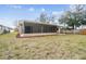 House and backyard with screened porch at 2715 Narcissus Dr, Holiday, FL 34691