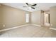 Spacious bedroom with ceiling fan and tile flooring at 2715 Narcissus Dr, Holiday, FL 34691