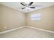 Simple bedroom with ceiling fan and tile floor at 2715 Narcissus Dr, Holiday, FL 34691