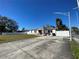 Updated home with a large driveway and a white fence at 2801 Auburn W Ave, Tampa, FL 33614