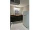 Small kitchenette with dark cabinets and white fridge at 2801 Auburn W Ave, Tampa, FL 33614