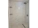 Modern shower with marble-look tiles and built-in shelves at 2801 Auburn W Ave, Tampa, FL 33614