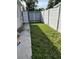 Small grassy side yard with white fence at 2801 Auburn W Ave, Tampa, FL 33614