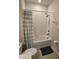 Bathroom with tub, shower, and a blue and white checkered curtain at 2878 Grand Kemerton Pl, Tampa, FL 33618