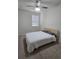 Bedroom with ceiling fan and striped bedding at 2878 Grand Kemerton Pl, Tampa, FL 33618