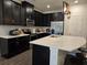 Modern kitchen with dark cabinetry, white countertops, and stainless steel appliances at 2878 Grand Kemerton Pl, Tampa, FL 33618