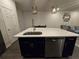 Kitchen island with white countertop, stainless steel sink, and dishwasher at 2878 Grand Kemerton Pl, Tampa, FL 33618