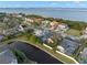 Aerial view of waterfront homes, including one with a pool at 3190 Shoreline Dr, Clearwater, FL 33760