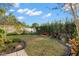 Landscaped backyard with spacious lawn and garden at 3190 Shoreline Dr, Clearwater, FL 33760