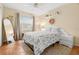 Bedroom with a full bed, floral bedding, and a large mirror at 3190 Shoreline Dr, Clearwater, FL 33760