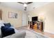 Bedroom with light gray sofa, TV stand and ceiling fan at 3190 Shoreline Dr, Clearwater, FL 33760