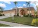 Single-story home with a two-car garage and landscaped lawn at 3190 Shoreline Dr, Clearwater, FL 33760