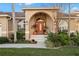 Inviting front entrance with a terracotta-tiled walkway and lush landscaping at 3190 Shoreline Dr, Clearwater, FL 33760