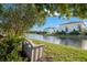 Peaceful waterfront view from backyard with bench seating at 3190 Shoreline Dr, Clearwater, FL 33760