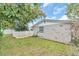 Side yard with a large tree and grassy area at 3405 Nixon Rd, Holiday, FL 34691