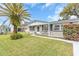 Newly renovated single story home with a landscaped lawn at 3405 Nixon Rd, Holiday, FL 34691