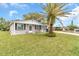 Newly renovated single story home with a landscaped lawn at 3405 Nixon Rd, Holiday, FL 34691