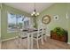 Charming dining area with white table and green walls at 3578 Indigo Pond Dr, Palm Harbor, FL 34685