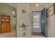 Bright condo entryway with wooden cabinet and blue door at 3578 Indigo Pond Dr, Palm Harbor, FL 34685